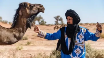Amazigh people wearing traditional clothing in a Moroccan village