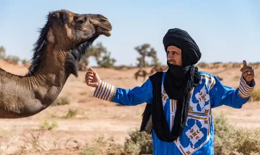 Amazigh people wearing traditional clothing in a Moroccan village