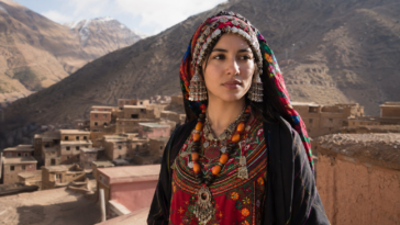 Young Amazigh woman in Morocco wearing traditional clothing in a mountain village
