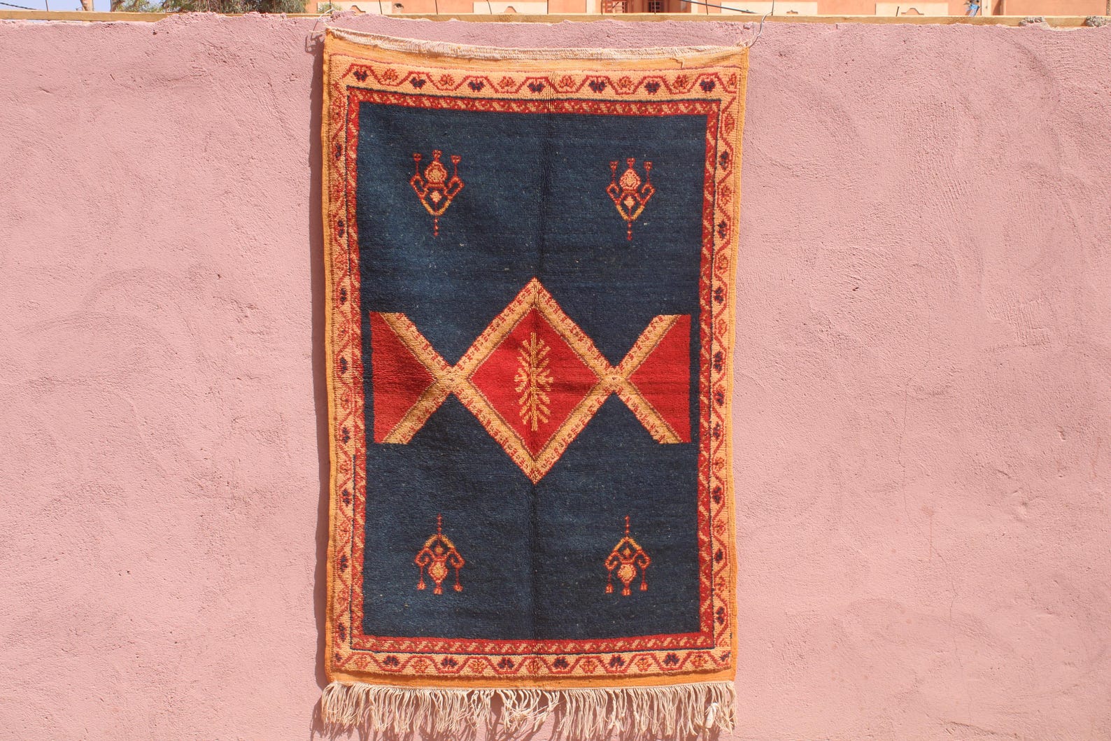 Hand-knotted Berber Amazigh Navy Diamond Rug with symbols believed to carry meaning