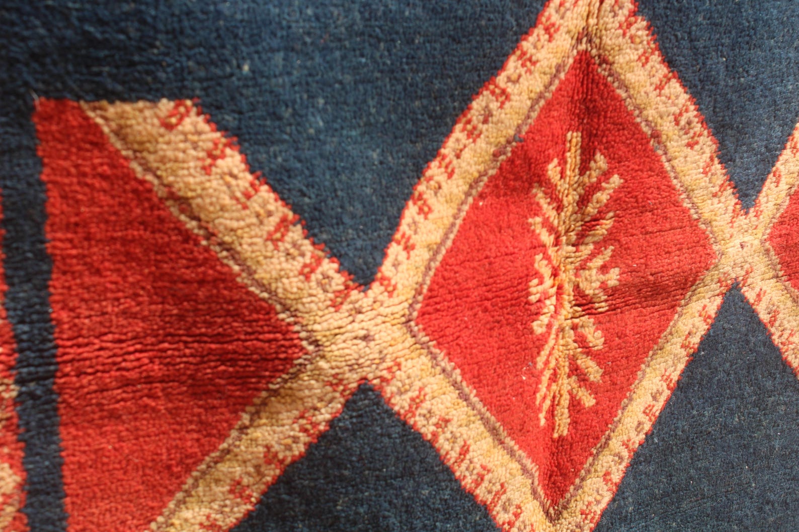 Hand-knotted Berber Amazigh Navy Diamond Rug with symbols believed to carry meaning
